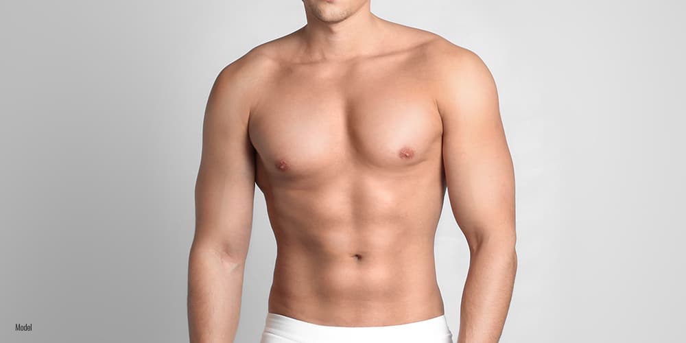 shirtless male in grey background